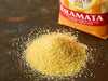 Moretti Bramata Coarse Ground Cornmeal 1.1lb, visible coarse yellow grains in a white bowl with a wooden spoon, close-up